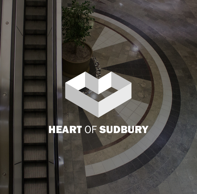 Heart of Sudbury logo over a photo of the escalator inside the Rainbow Mall