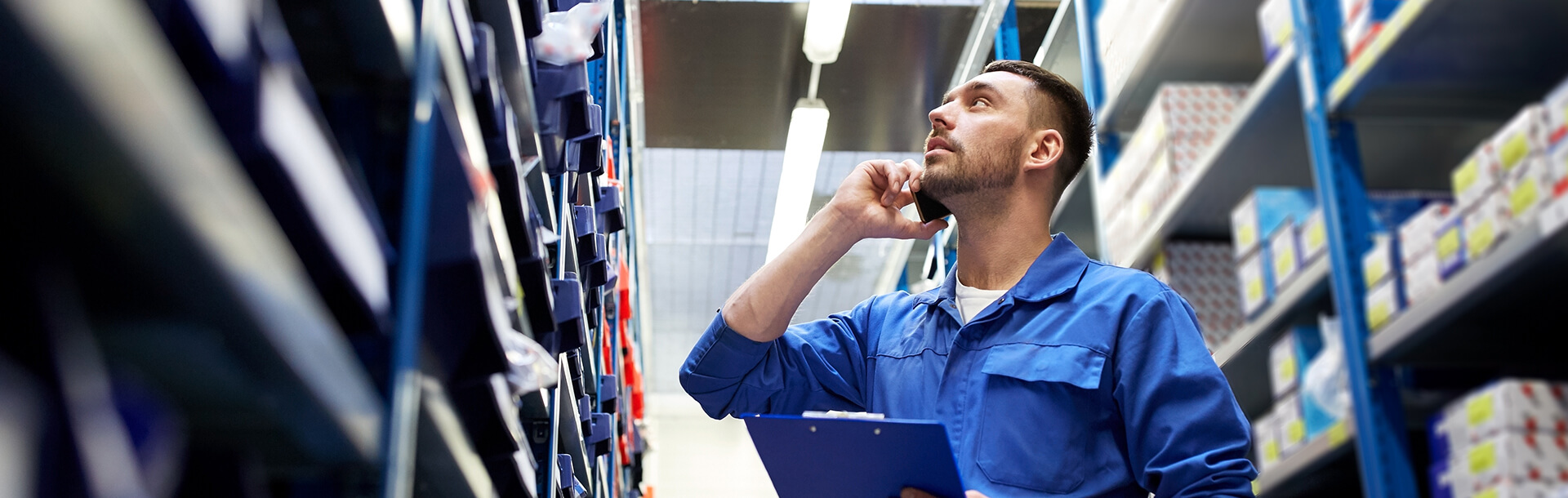 maslack employee looking at shelves while talking on cell phone